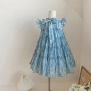 Blue tiered dress on a mannequin against a white wall, Obroi