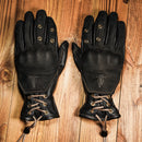 Pair of black leather gloves with lace-up design on a wooden , Obroi