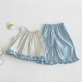 A baby girl's two-piece clothing set laid flat on a textured white background. The set includes a sleeveless top in cream and light blue with vertical stripes and a ruffled hem, paired with light blue elastic-waist shorts, Obroi