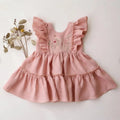 Pink children's dress with floral embroidery on a white background, Obroi