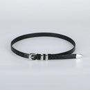 Black leather belt with silver buckle on a light gray background, Obroi