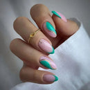 Hand with pink and teal nail design on a neutral background, Obroi