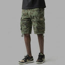 Person wearing camouflage cargo shorts on a gray background, Obroi