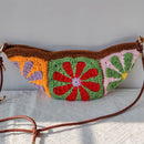 Colorful crochet bag with floral patterns on a white surface, Obroi