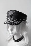 Black leather cap with skull and leopard print visor on a mannequin head against a white background, Obroi