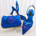 Blue high-heeled shoes and matching handbag with embellishments on a white background, Obroi