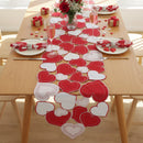 Dining table set with heart-themed placemats, glasses, and napkins on a wooden table, Obroi