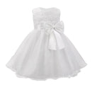 White flower girl dress with a large bow on a white background, Obroi