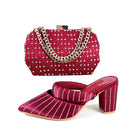 Red shoe and handbag set with rhinestone details on a white background, Obroi