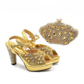 Gold high-heeled shoes with floral designs and a matching clutch on a white background, Obroi