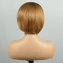 Short bob wig in a warm golden blonde shade, shown from the back on a mannequin head against a light gray background, Obroi