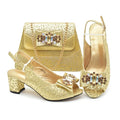 Gold high-heeled shoes and matching handbag with embellishments on a white background, Obroi