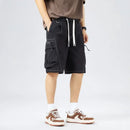 Person wearing black cargo shorts on a white background, Obroi