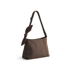Brown shoulder bag with a bow detail on a white background, featuring the  Obroi brand.