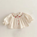 White blouse with red embroidery and buttons on a light gray background, Obroi