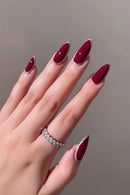 Hand with burgundy nail polish on a neutral background, Obroi