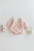 Pink baby romper with lace details on a white background, Obroi