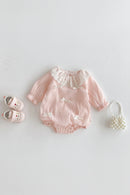Pink baby romper with lace details on a white background, Obroi