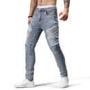 Person wearing light blue jeans with patchwork design on a white background, brand 'Obroi' visible.