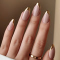 Close-up of a hand with pink and gold nail polish on a neutral background, Obroi