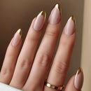 Close-up of a hand with pink and gold nail polish on a neutral background, Obroi