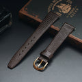 Brown leather watch strap with gold buckle on a dark surface, Obroi