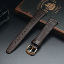 Brown leather watch strap with gold buckle on a dark surface, Obroi