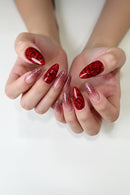 Close-up of hands with red floral nail art on a white background, Obroi
