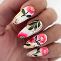 Nails with floral design held in a hand, Obroi