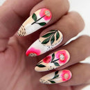 Nails with floral design held in a hand, Obroi