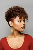 Woman with short, curly hair wearing gold earrings against a gray background, Obroi