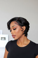 Woman with a stylish haircut wearing a black shirt against a neutral background, Obroi