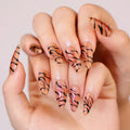 Nails with tiger stripe design on a neutral background, Obroi