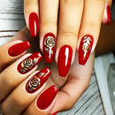 Red nail polish with gold rose designs on a neutral background, Obroi