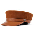 Brown suede cap with leather band and star emblem on a white background, Obroi