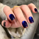 Hand with blue nail polish on a blurred background, Obroi