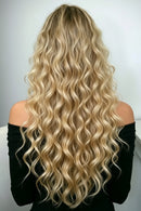 Person with long, wavy blonde hair in a styling session, Obroi