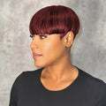 Woman with burgundy hair styled in a bob against a neutral background, Obroi
