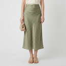 Woman wearing a green polka dot skirt on a white background, Obroi
