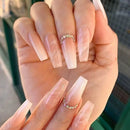 Hand with long, clear acrylic nails and diamond , Obroi