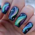 Nails with galaxy design featuring green, purple, and black colors, Obroi