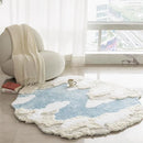 Round cloud-patterned rug on a light wooden floor with a chair and window in the background, Obroi
