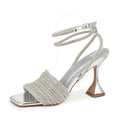 Silver high-heeled shoe with beaded design on a white background, Obroi
