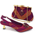 A matching women's evening set featuring a pair of pointed-toe slingback pumps and a structured clutch handbag, both embellished with deep magenta and gold rhinestone patterns and floral crystal accents, Obroi