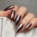 Hand with metallic rainbow nail design on a neutral background, Obroi