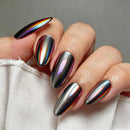 Hand with metallic rainbow nail design on a neutral background, Obroi