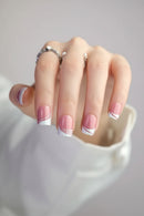 Hand with pink nail polish and a ring on a neutral background, Obroi