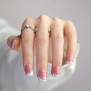Hand with pink nail polish and a ring on a neutral background, Obroi