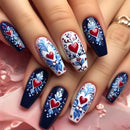 Nails with floral and heart designs on a pink fabric background, Obroi