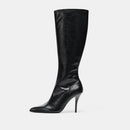 Black knee-high boot with a high heel on a light gray background, Obroi